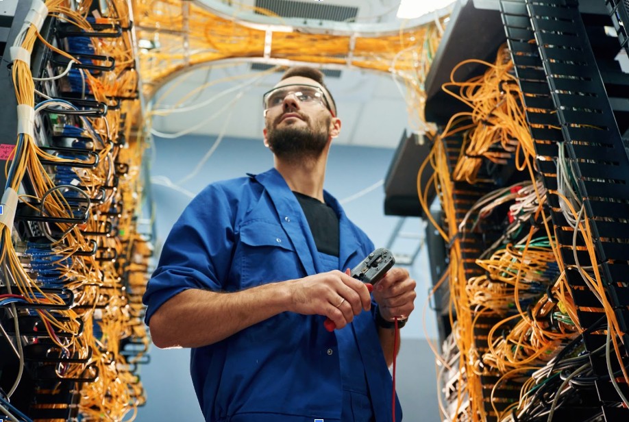 Man cutting the wire in a server room