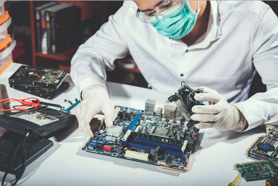 electronics technician repairing computer