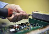 image of electronics technician hands working