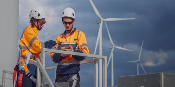 Maintenance team inspecting wind turbine